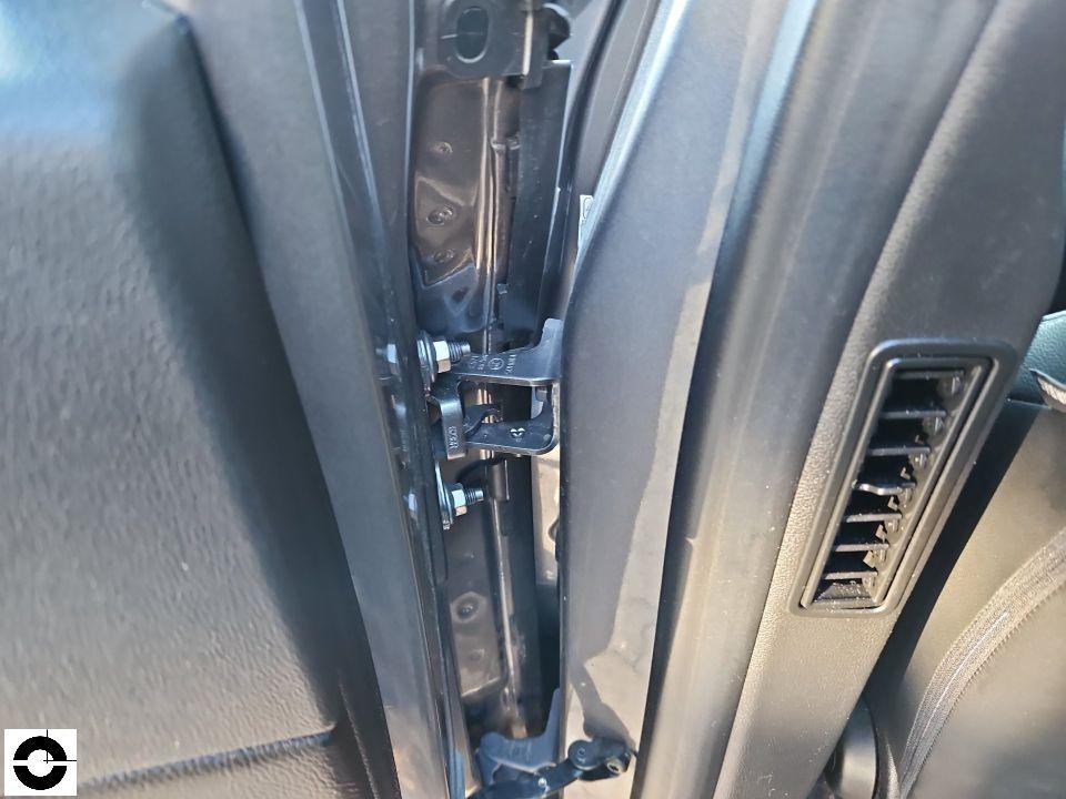 Detailaufnahme der B-Säulenverkleidung und Türscharniere, Fahrerseite, Innenraum sichtbar