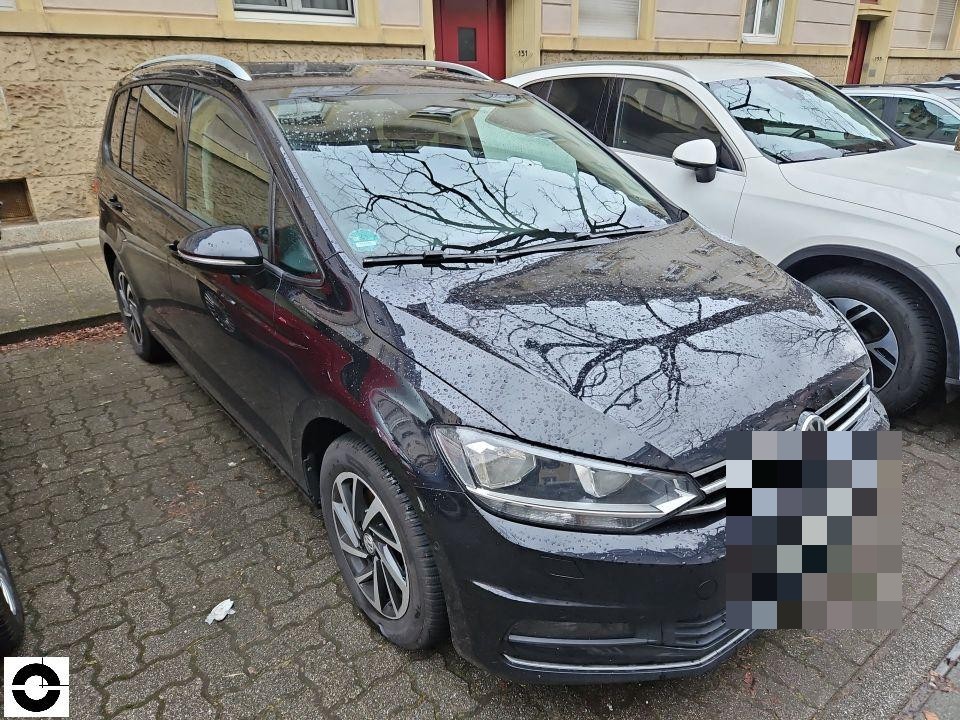 Frontansicht schräg links, schwarzes Fahrzeug, Motorhaube mit Regentropfen, keine sichtbaren Schäden