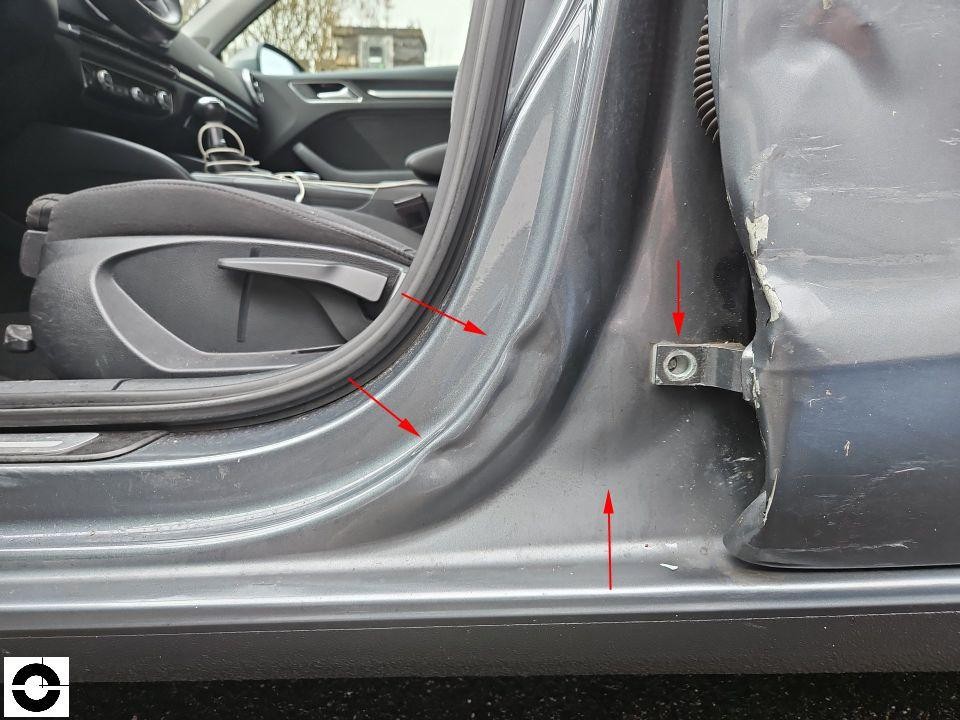 B-Säule links mit Unfallschäden, rote Pfeile markieren Deformationen und Lackschäden