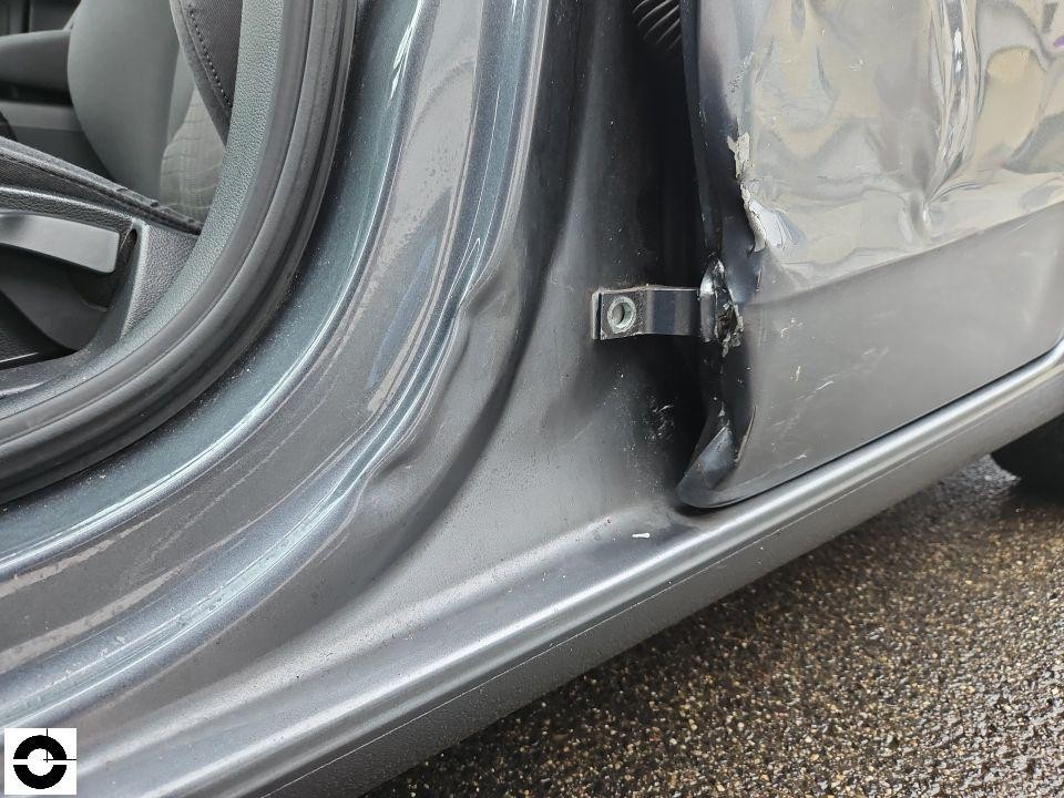 Detailaufnahme B-Säule links unten mit Deformation und Lackschäden, Schwellerbereich