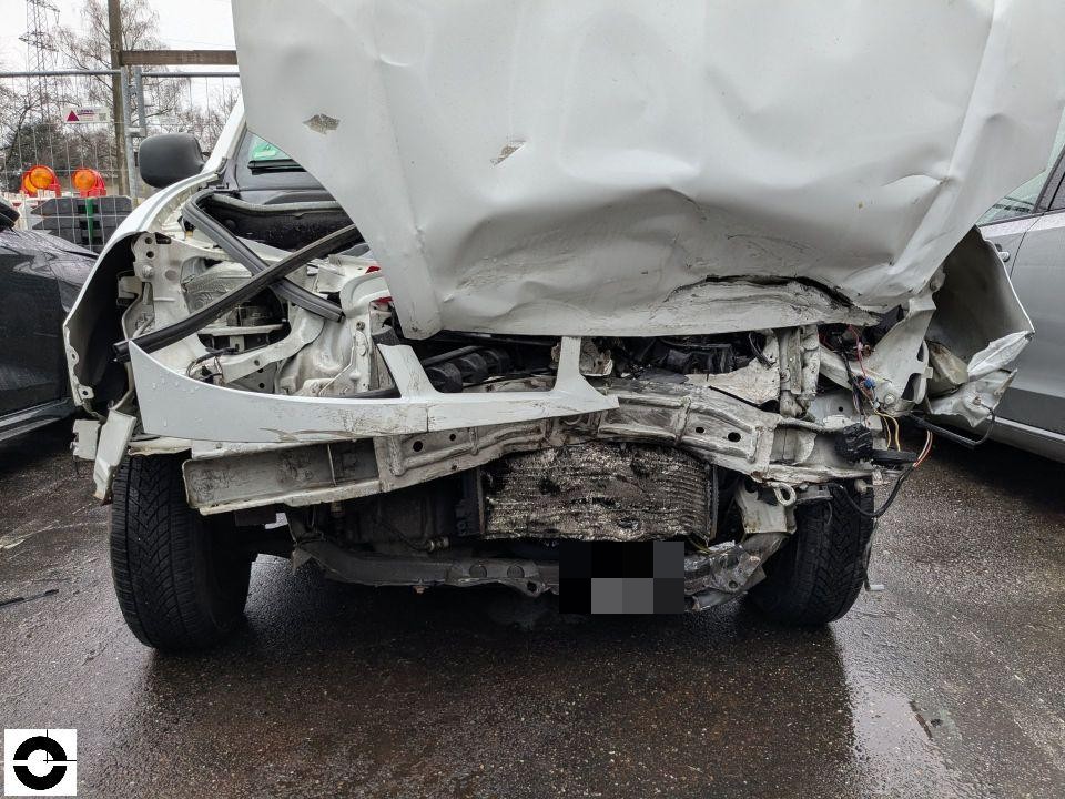 Frontansicht mit schwerem Unfallschaden, Motorhaube aufgestellt, Kühler und Frontpartie komplett zerstört