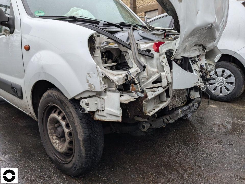 Schwerer Frontschaden rechts, Motorraum freigelegt, Stoßfänger und Kotflügel fehlen, VW im Hintergrund